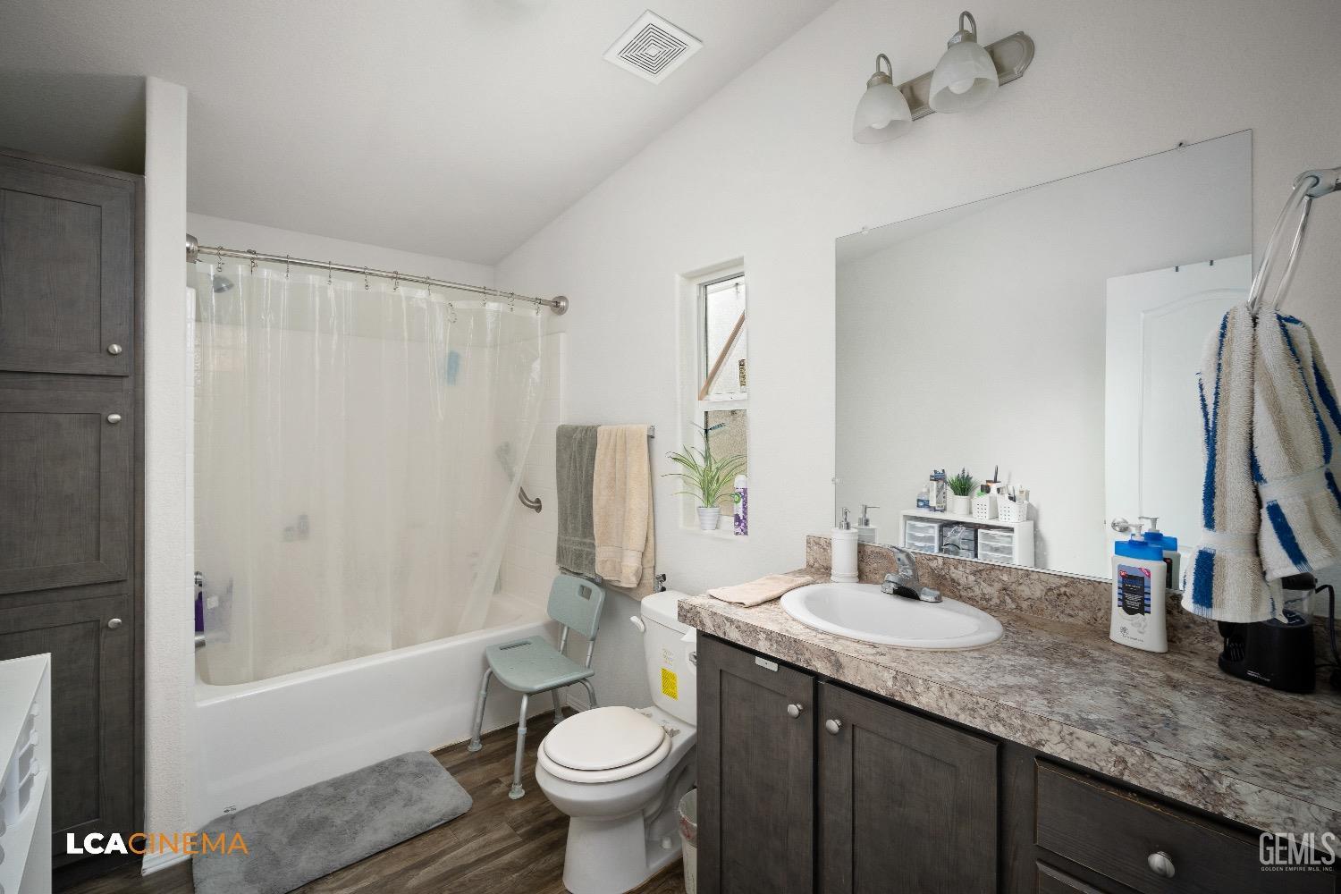 Undisclosed Address Bakersfield, CA 93304 - Photo 15 of 18 a bathroom with a granite countertop sink toilet and shower