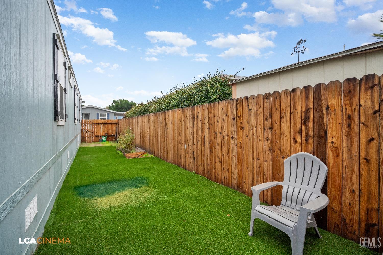 Undisclosed Address Bakersfield, CA 93304 - Photo 17 of 18 a view of a backyard with wooden fence