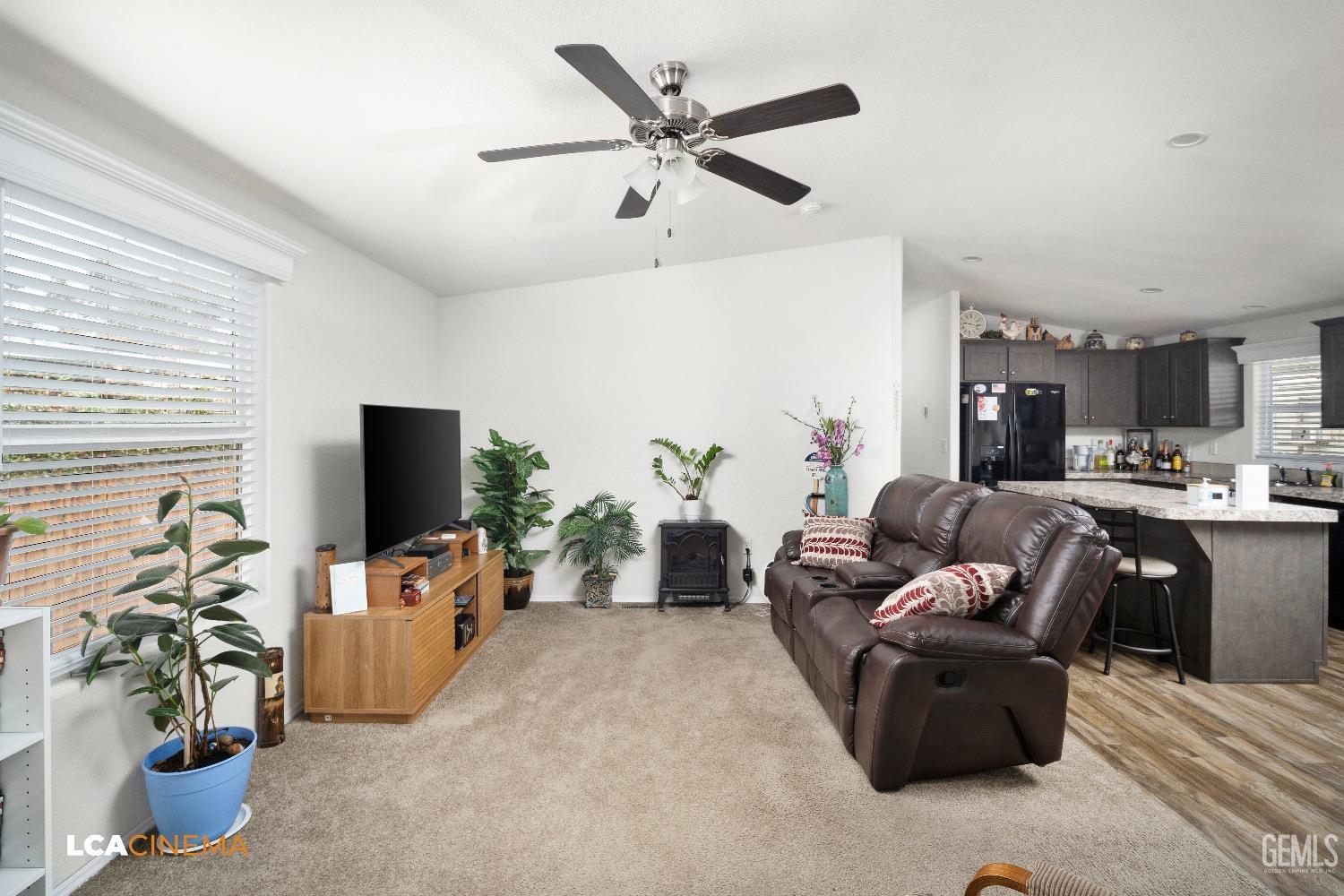 Undisclosed Address Bakersfield, CA 93304 - Photo 5 of 18 a living room with furniture a flat screen tv and a window