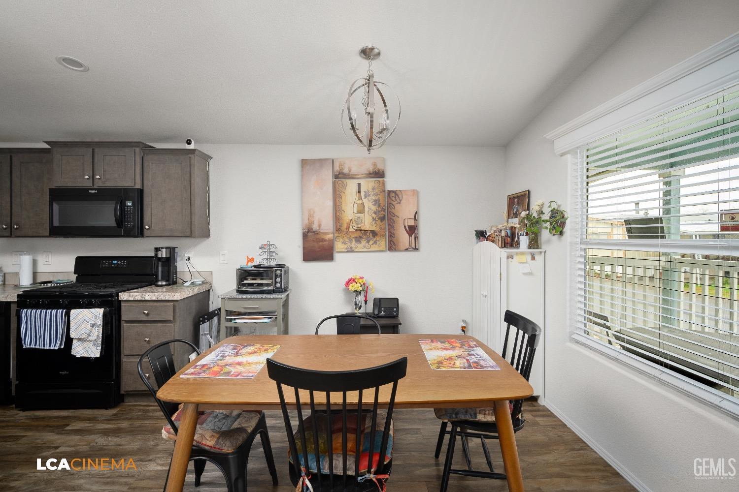 Undisclosed Address Bakersfield, CA 93304 - Photo 7 of 18 a view of a dining room with furniture window and wooden floor