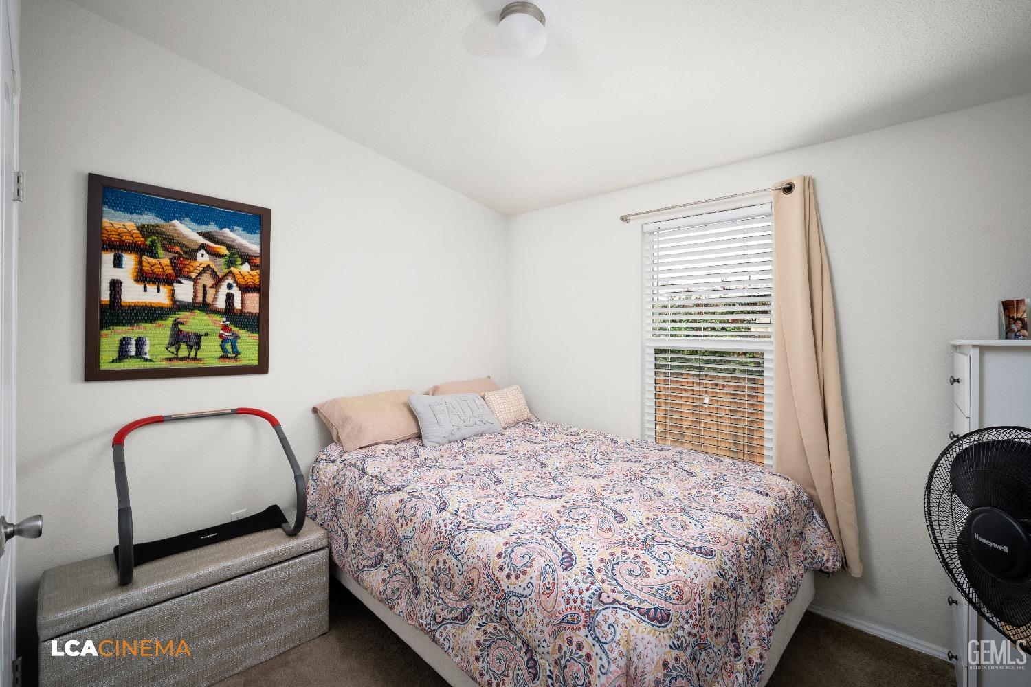 Undisclosed Address Bakersfield, CA 93304 - Photo 10 of 18 a bedroom with a bed and a large window