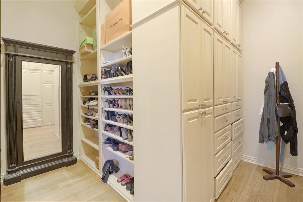 219 High Point Drive Murphy, TX 75094 - Photo 12 of 30 HUGE Walk-in closet with built-in shelves and plenty of storage for clothes and shoes.