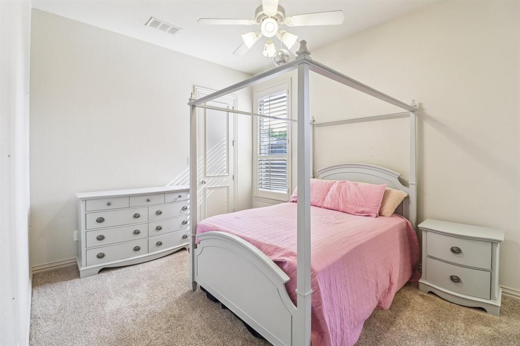 219 High Point Drive Murphy, TX 75094 - Photo 13 of 30 Secondary Bedroom downstairs with a canopy bed, good natural light, and jack and Jill bathroom
