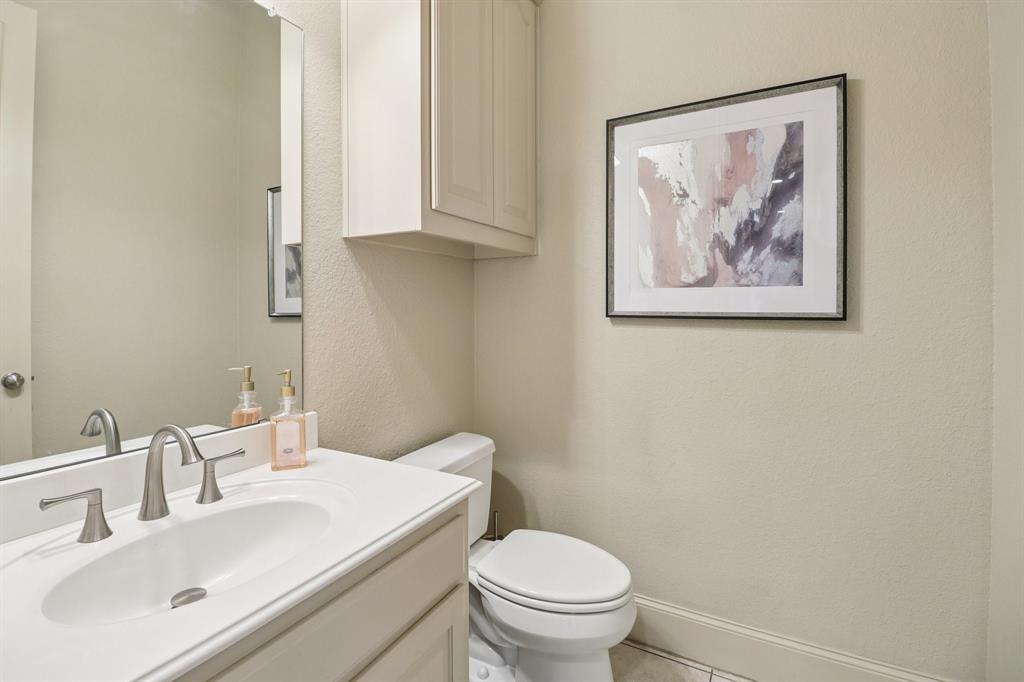 219 High Point Drive Murphy, TX 75094 - Photo 16 of 30 Half bath with a clean look and a simple vanity.