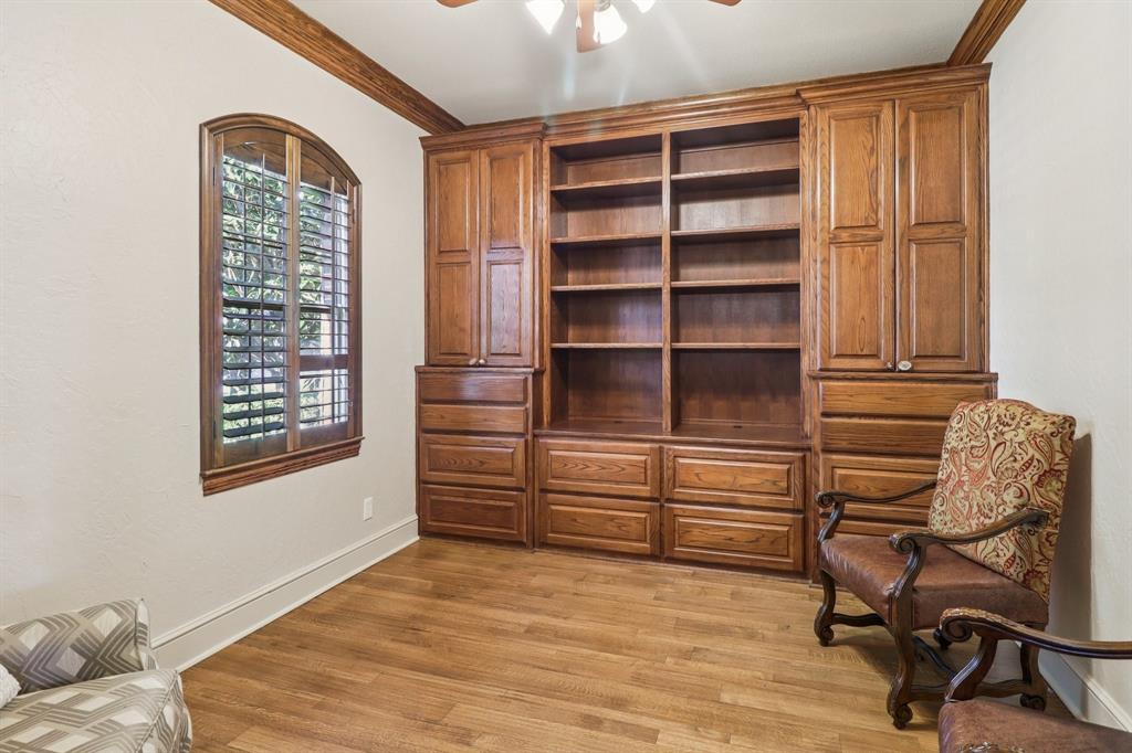 219 High Point Drive Murphy, TX 75094 - Photo 4 of 30 Home office or study with built-in shelves and warm wood details.