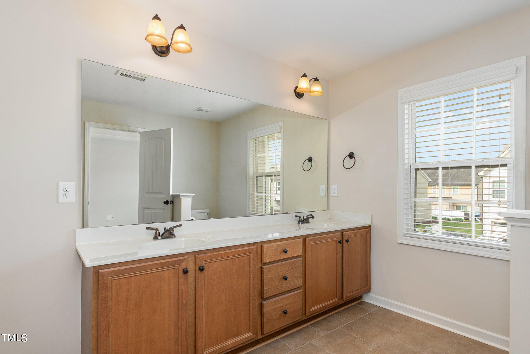 206 Leighann Ridge Lane Rolesville, NC 27571 - Photo 24 of 38 a spacious bathroom with 2 sink and a mirror