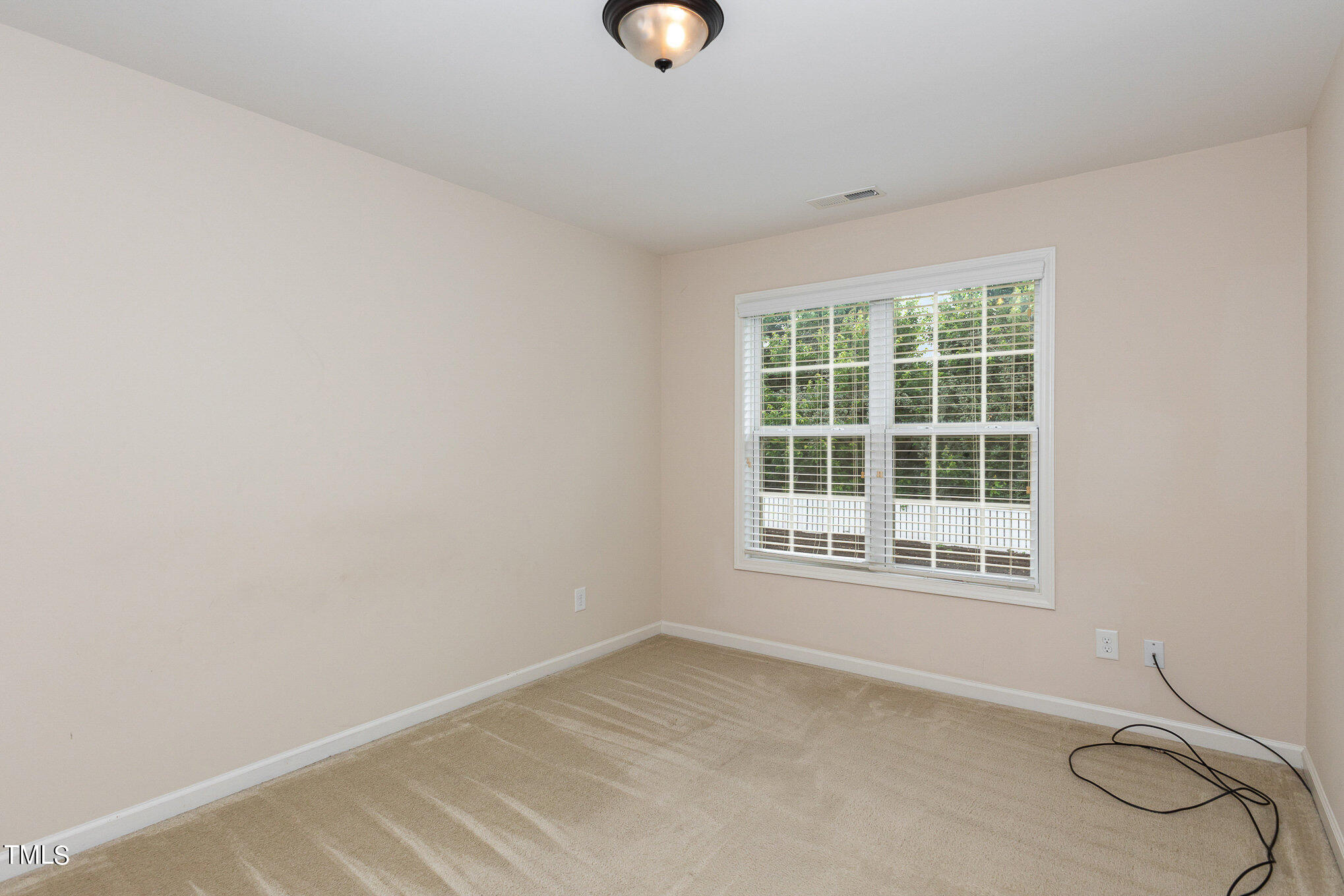206 Leighann Ridge Lane Rolesville, NC 27571 - Photo 26 of 38 a view of an empty room with wooden floor and windows
