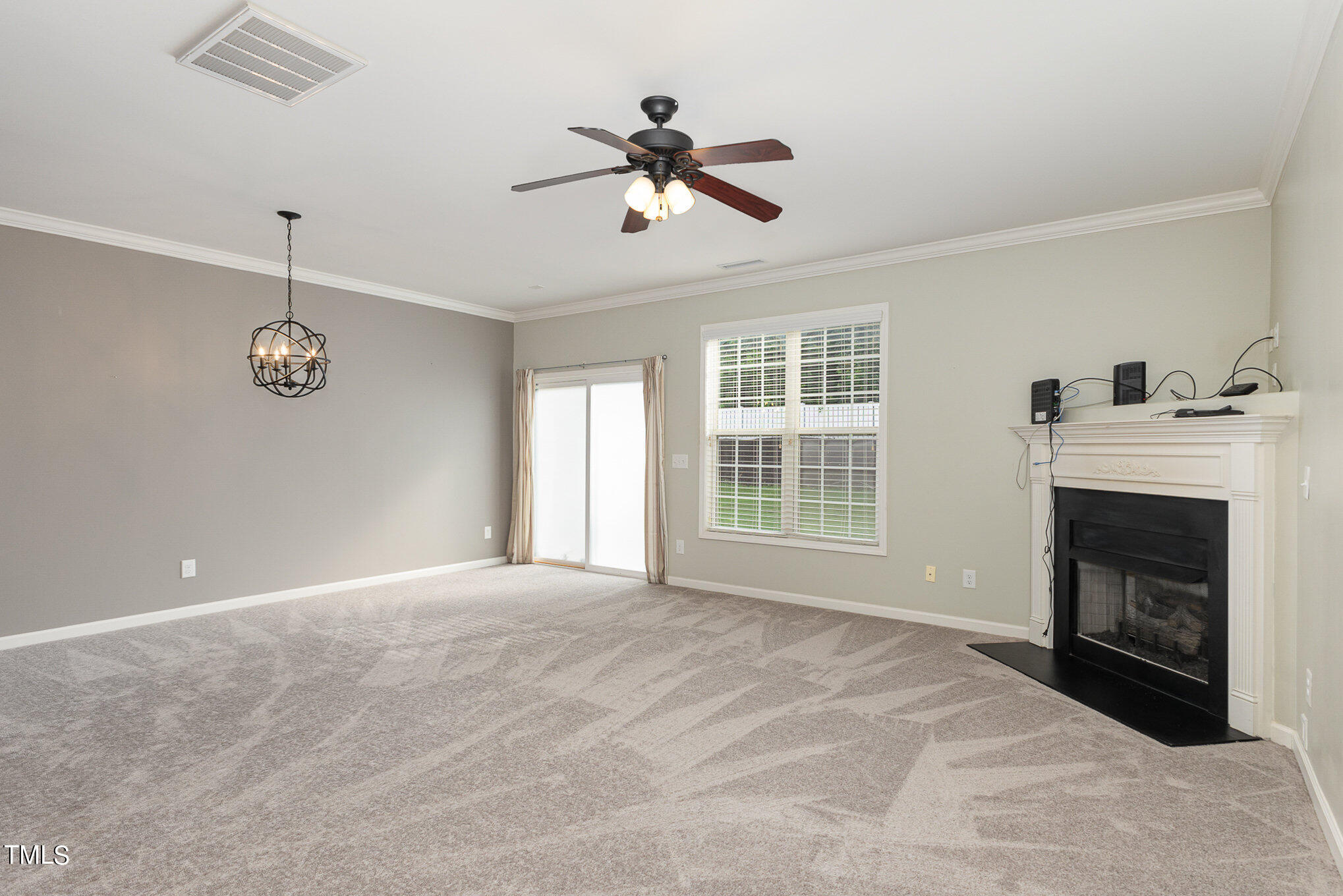 206 Leighann Ridge Lane Rolesville, NC 27571 - Photo 6 of 38 a view of an empty room with a fireplace and a window