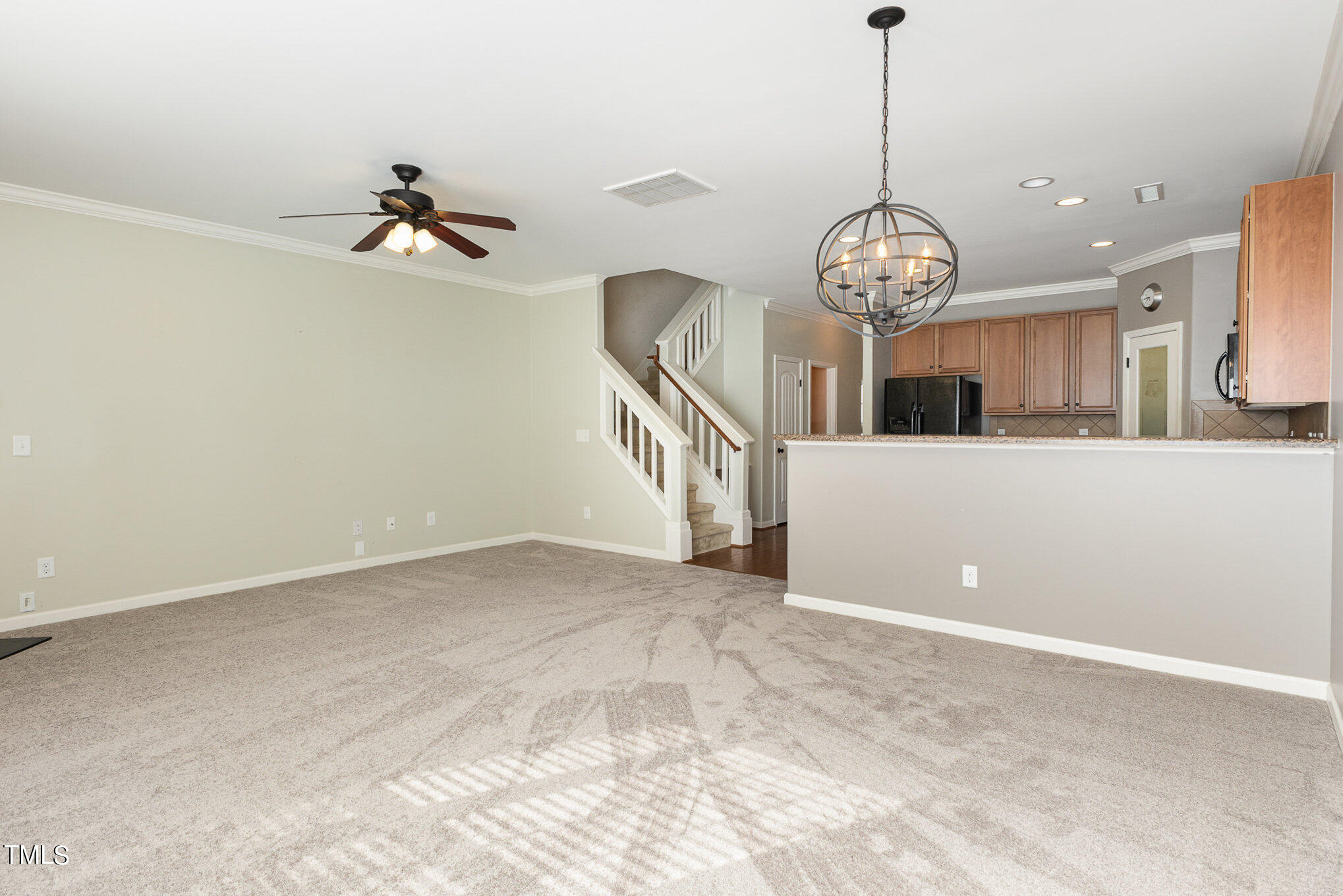 206 Leighann Ridge Lane Rolesville, NC 27571 - Photo 9 of 38 a view of a room with a chandelier fan and kitchen view
