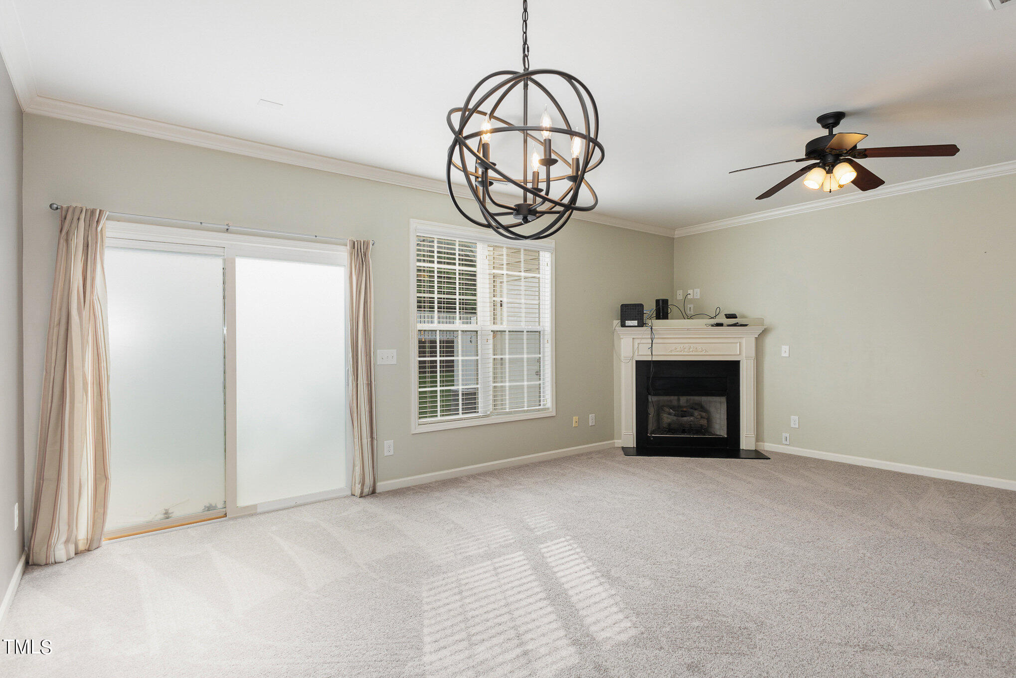 206 Leighann Ridge Lane Rolesville, NC 27571 - Photo 10 of 38 a view of an empty room with a fireplace and a window