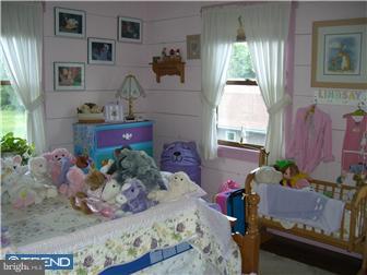 75 Gilbert Road Bordentown, NJ 08505 - Photo 9 of 12 a bedroom with a bed potted plant on dresser and a window