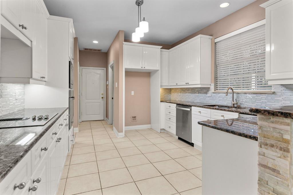 2 Shields Court Trophy Club, TX 76262 - Photo 16 of 39 a kitchen with granite countertop a stove sink and cabinets