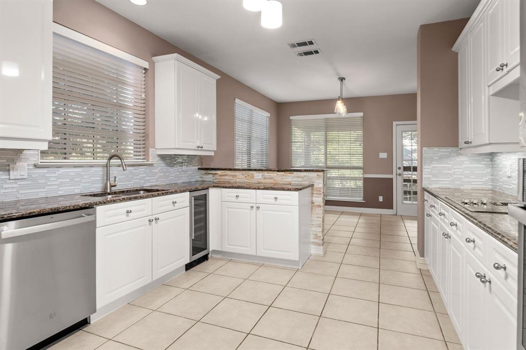 2 Shields Court Trophy Club, TX 76262 - Photo 17 of 39 a kitchen with a stove a sink and a refrigerator
