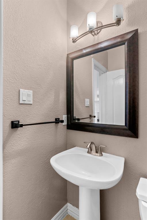 2 Shields Court Trophy Club, TX 76262 - Photo 19 of 39 a bathroom with a sink a mirror and a toilet