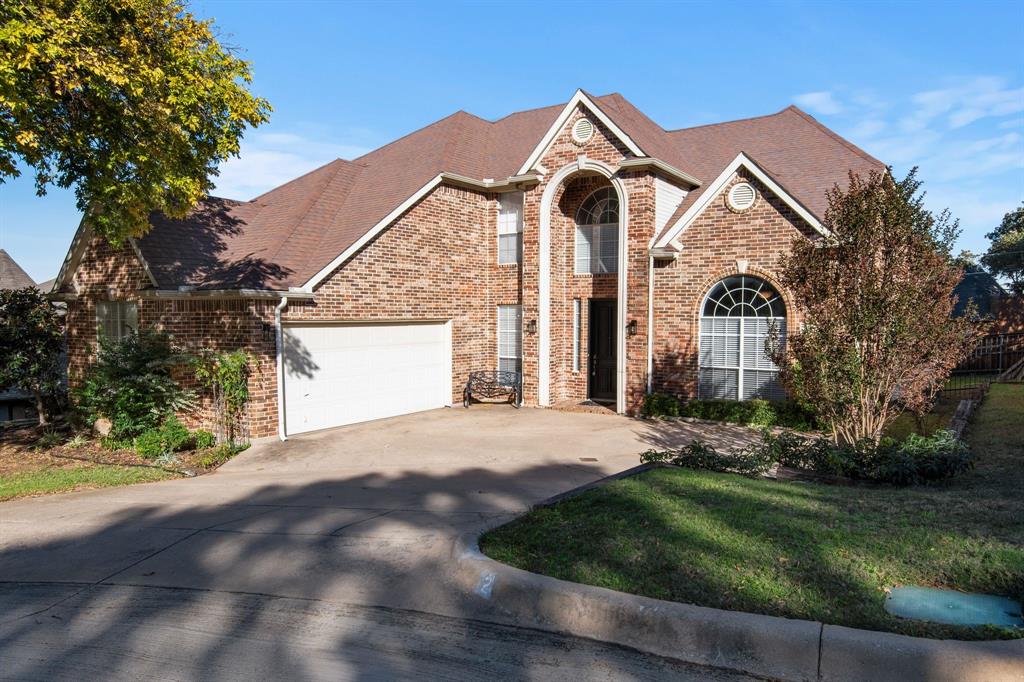 2 Shields Court Trophy Club, TX 76262 - Photo 2 of 39 a front view of a house with a yard and garage