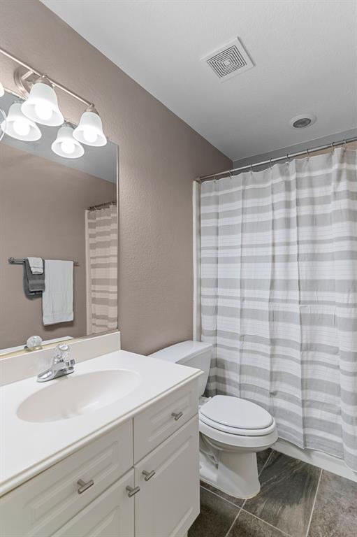 2 Shields Court Trophy Club, TX 76262 - Photo 29 of 39 a bathroom with a sink a toilet and shower curtain