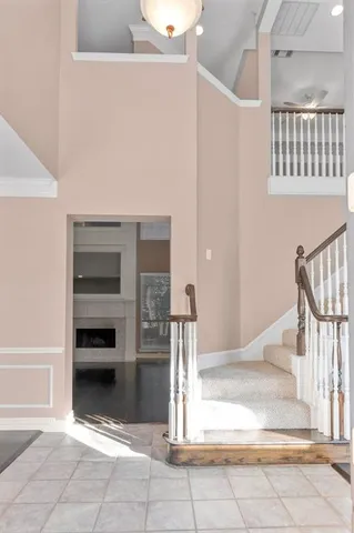 a view of staircase with white walls and railing