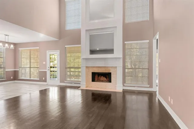 a view of a livingroom with wooden floor and a fireplace