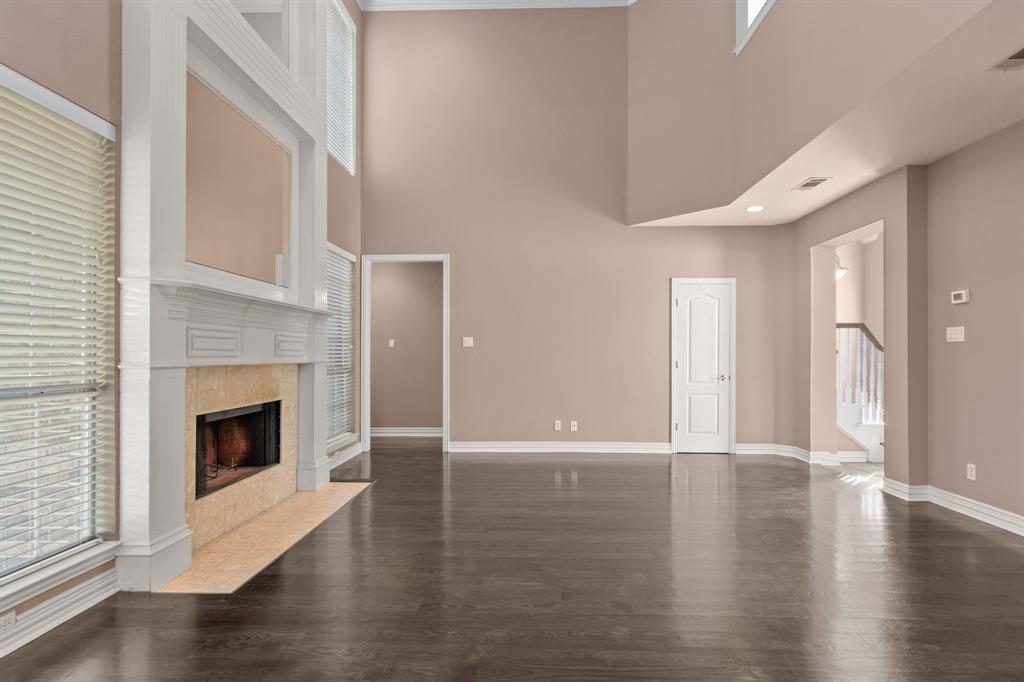 2 Shields Court Trophy Club, TX 76262 - Photo 10 of 39 a view of an empty room with wooden floor fireplace and a window