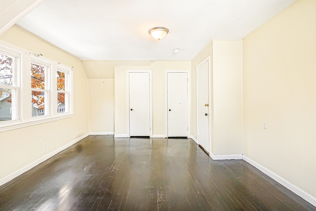 18 Sycamore Street Springfield, MA 01109 - Photo 13 of 22 a view of an empty room with wooden floor and a window
