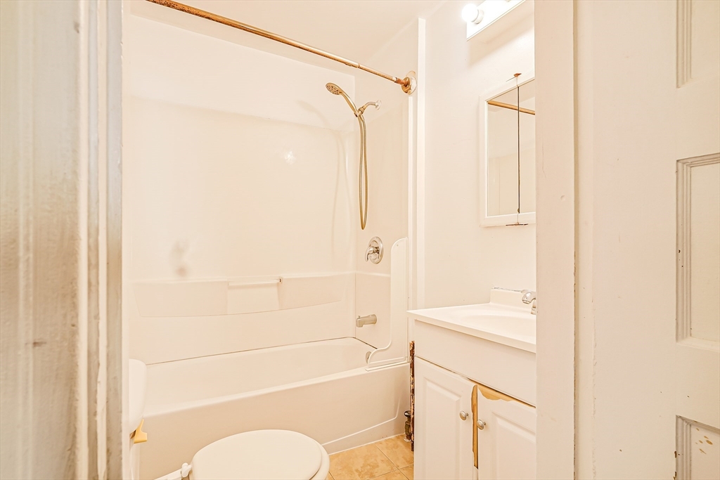 18 Sycamore Street Springfield, MA 01109 - Photo 17 of 22 a bathroom with a shower a sink and a toilet