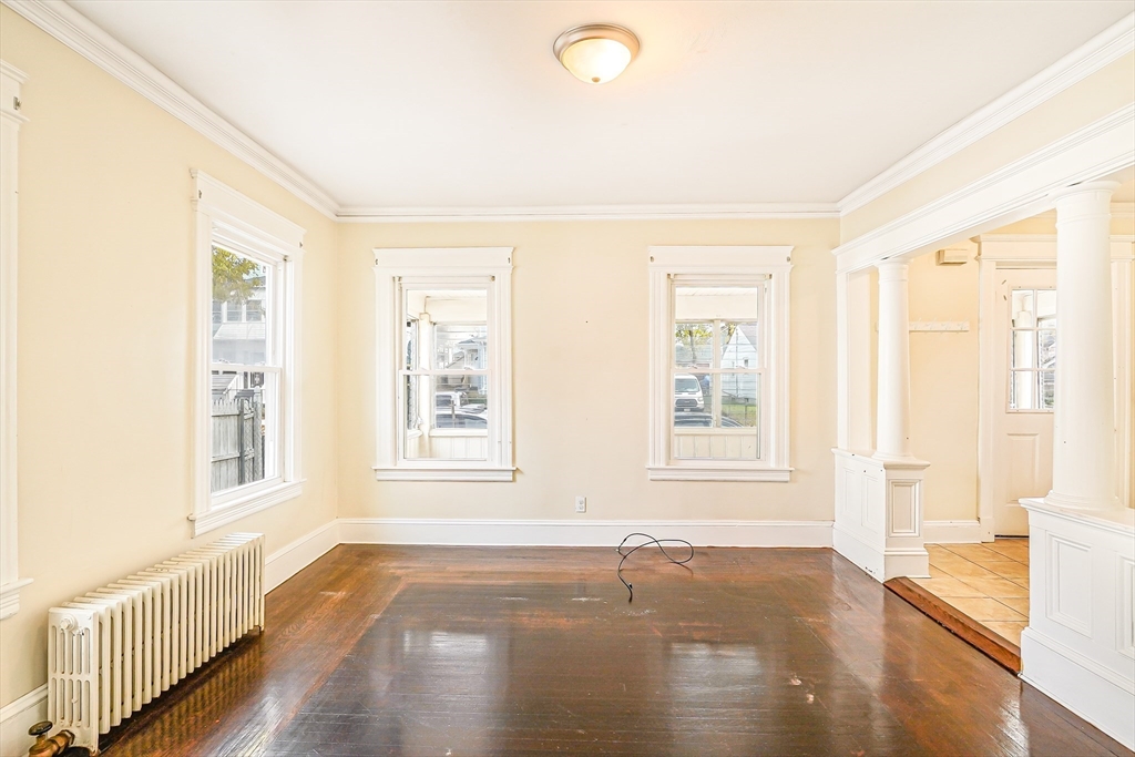 18 Sycamore Street Springfield, MA 01109 - Photo 7 of 22 a view of an empty room with wooden floor and a window