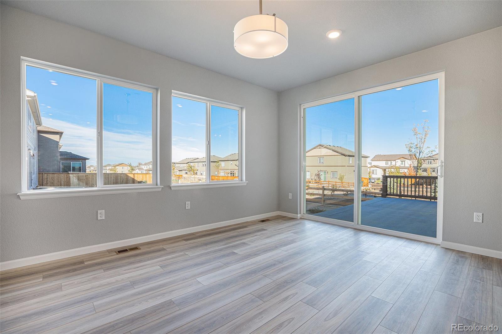 15965 Stringhalt Way Parker, CO 80134 - Photo 11 of 33 a view of an empty room with wooden floor and a window