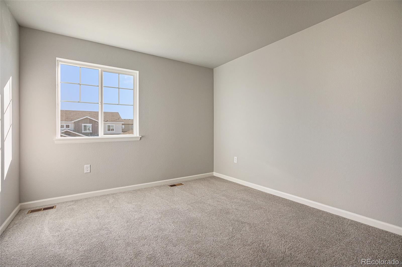 15965 Stringhalt Way Parker, CO 80134 - Photo 17 of 33 an empty room with windows