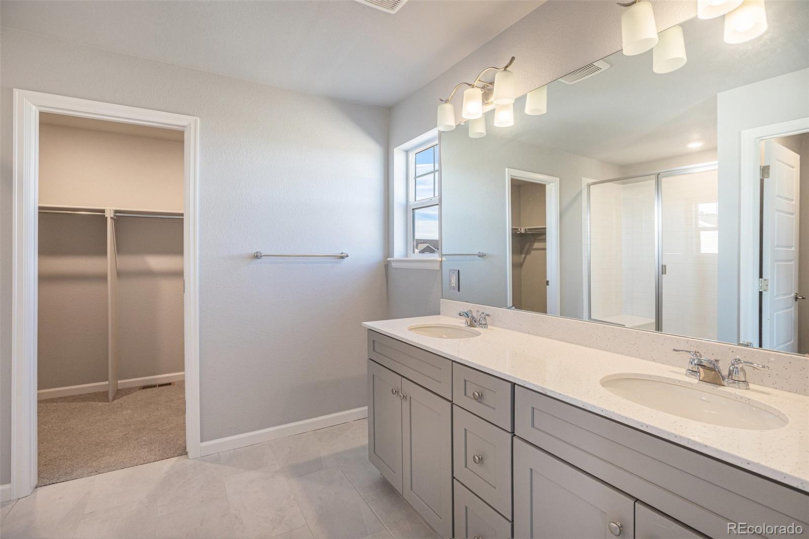 15965 Stringhalt Way Parker, CO 80134 - Photo 23 of 33 a bathroom with a sink and a mirror