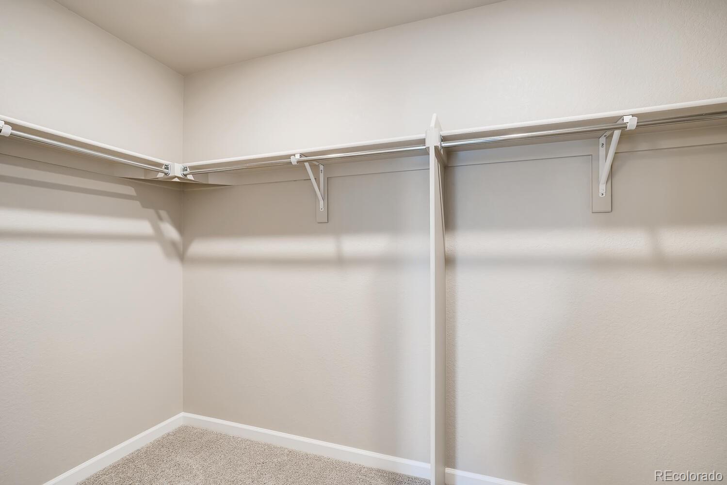 15965 Stringhalt Way Parker, CO 80134 - Photo 24 of 33 a view of an empty walk in closet