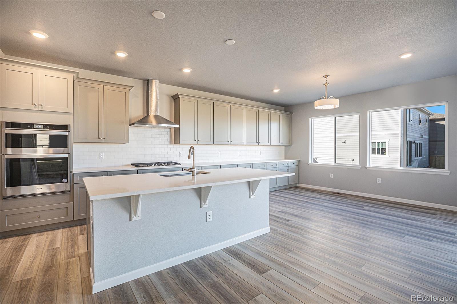 15965 Stringhalt Way Parker, CO 80134 - Photo 7 of 33 a large kitchen with stainless steel appliances granite countertop a large counter top a sink and a stove