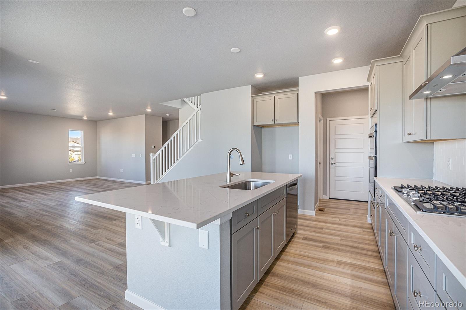 15965 Stringhalt Way Parker, CO 80134 - Photo 8 of 33 a kitchen with stainless steel appliances granite countertop a sink stove and refrigerator
