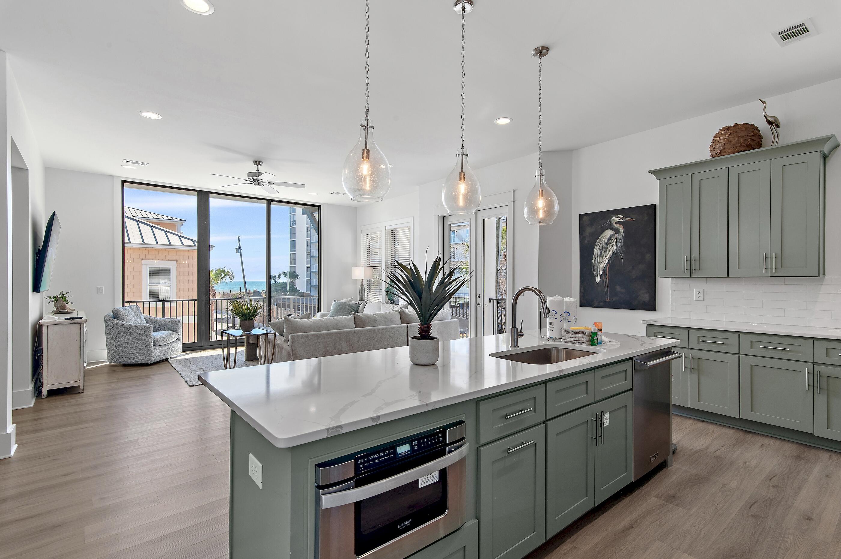 217 Snowdrift Road Miramar Beach, FL 32550 - Photo 16 of 66 a kitchen with stainless steel appliances granite countertop a sink a stove and a wooden floor