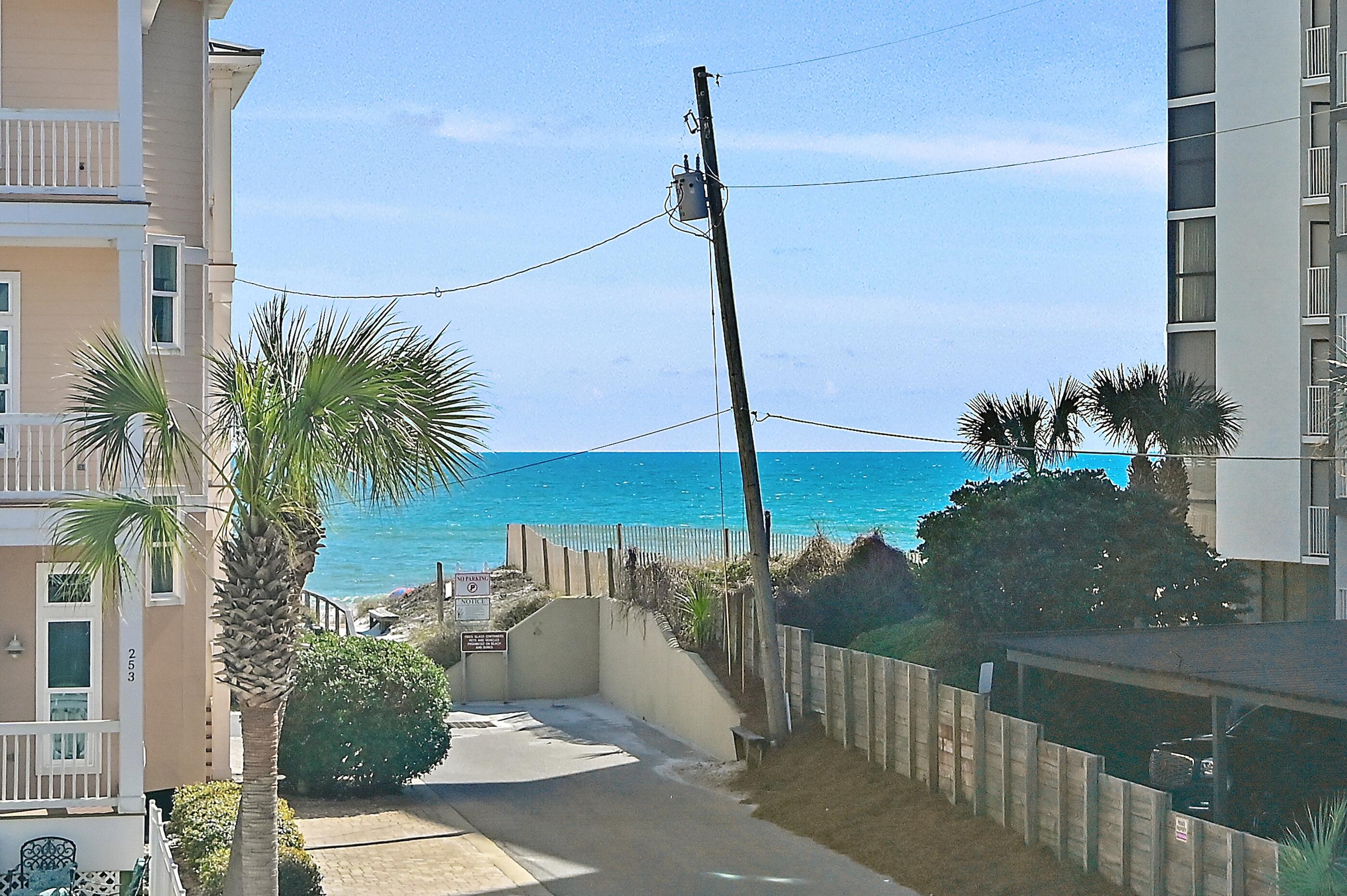 217 Snowdrift Road Miramar Beach, FL 32550 - Photo 20 of 66 a view of a balcony with floor to ceiling windows yard and palm tree
