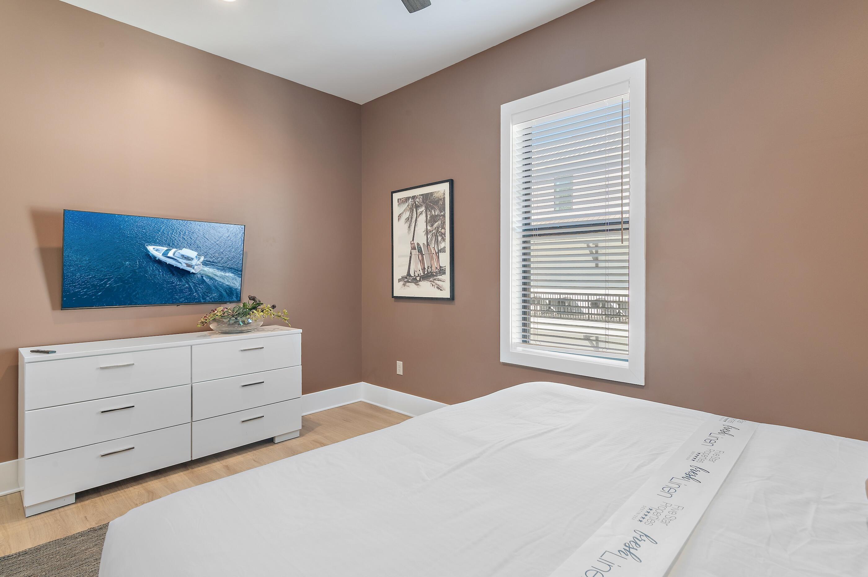 217 Snowdrift Road Miramar Beach, FL 32550 - Photo 35 of 66 a bedroom with a bed and a dresser in it