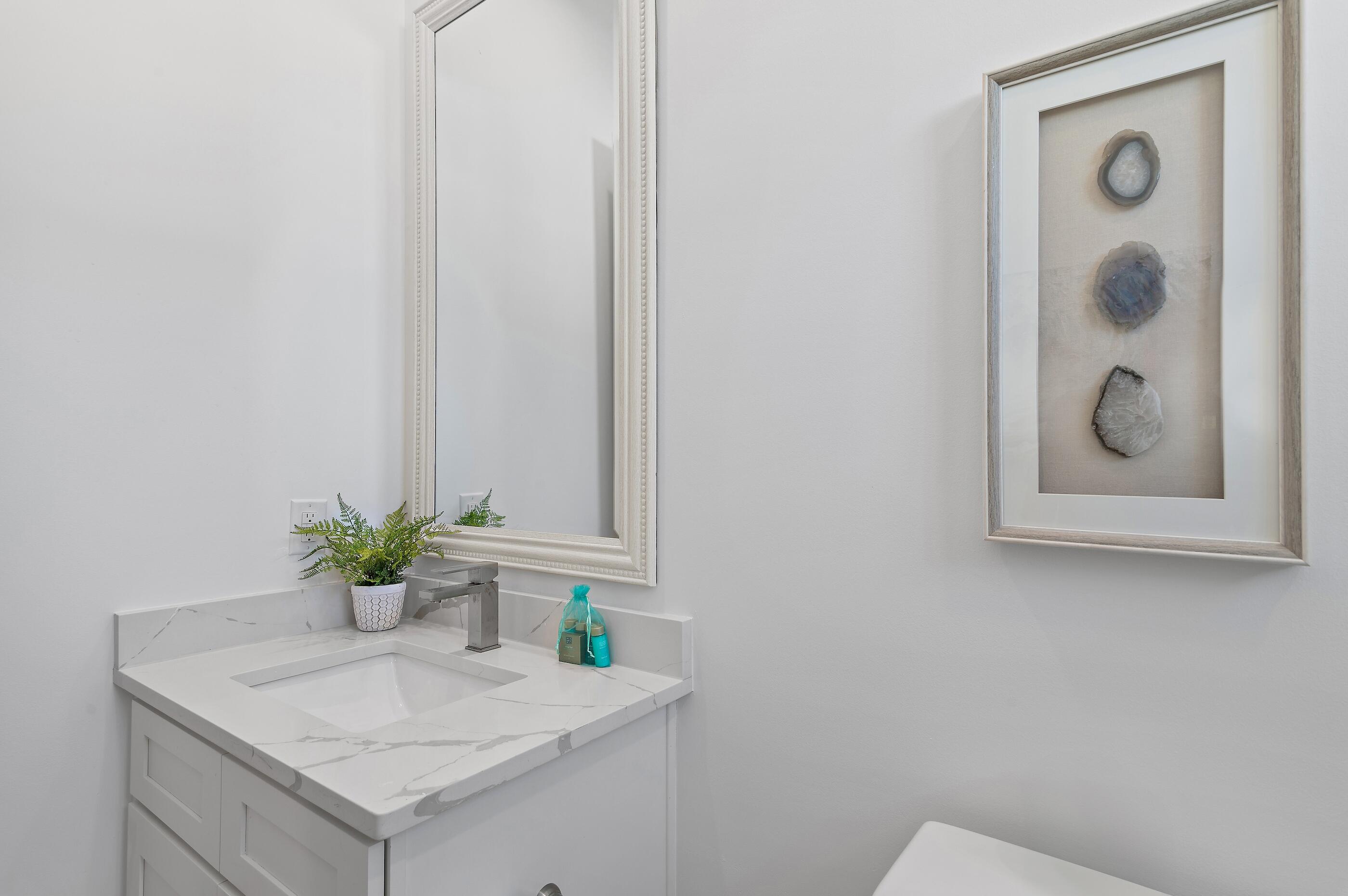 217 Snowdrift Road Miramar Beach, FL 32550 - Photo 42 of 66 a bathroom with a granite countertop sink and a mirror