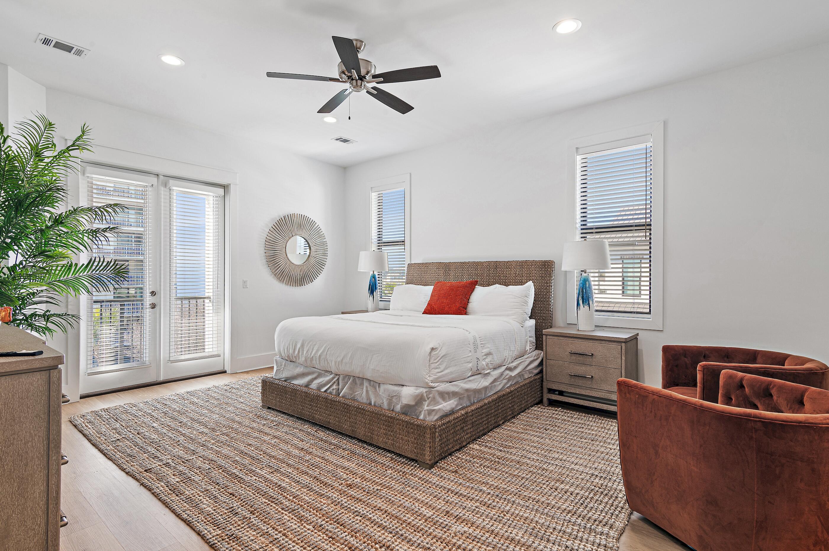 217 Snowdrift Road Miramar Beach, FL 32550 - Photo 44 of 66 a bedroom with a large bed and a chandelier