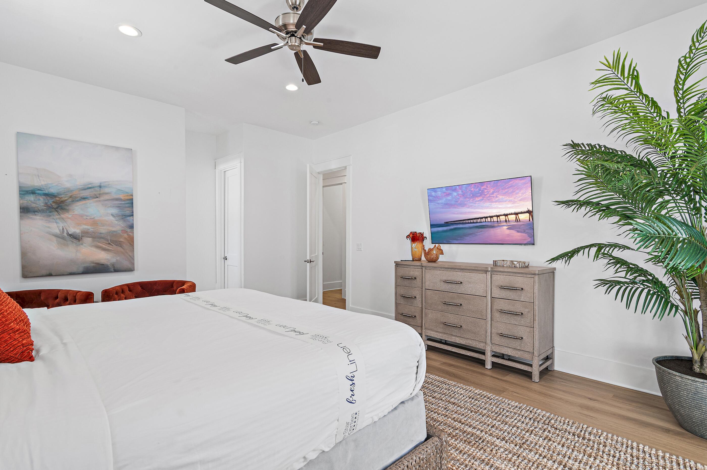 217 Snowdrift Road Miramar Beach, FL 32550 - Photo 45 of 66 a bedroom with a large bed and a chandelier