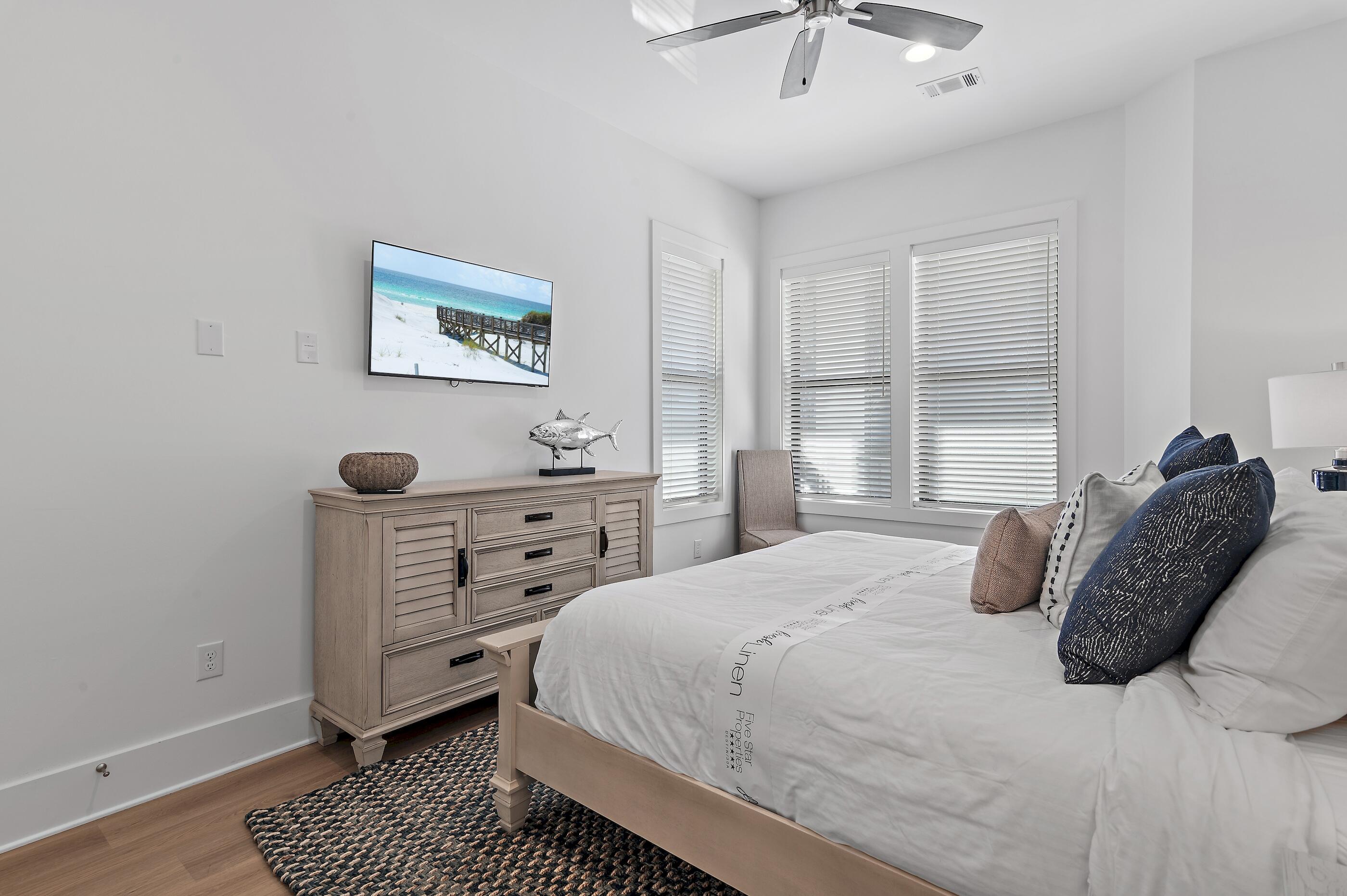 217 Snowdrift Road Miramar Beach, FL 32550 - Photo 64 of 66 a bedroom with a bed and a chandelier