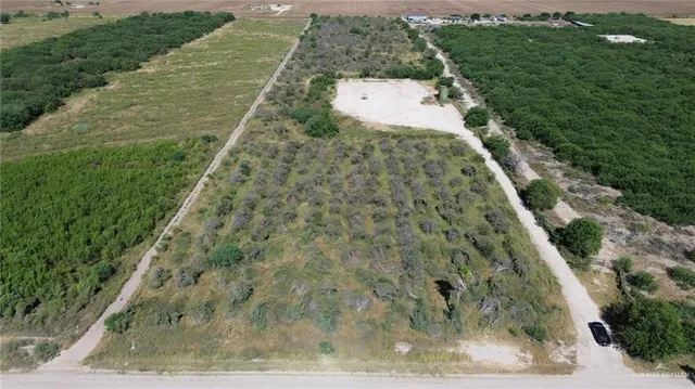 an aerial view of a houses with outdoor space and city view