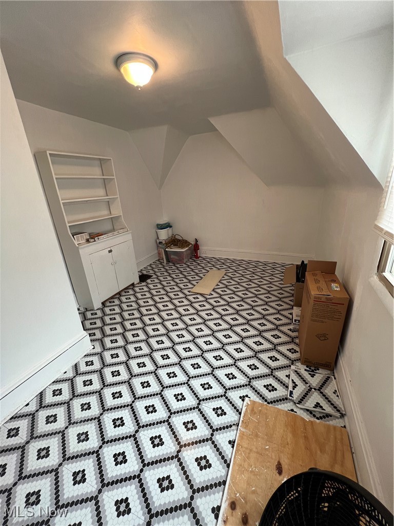 3362 Sutton Road Cleveland, OH 44120 - Photo 42 of 43 Additional living space featuring baseboards and vaulted ceiling