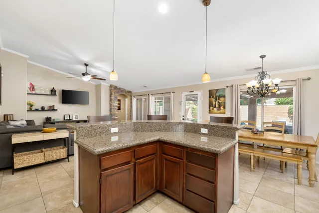 a kitchen with granite countertop a sink and white cabinets