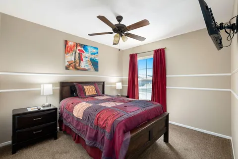 a bedroom with a bed and a chandelier