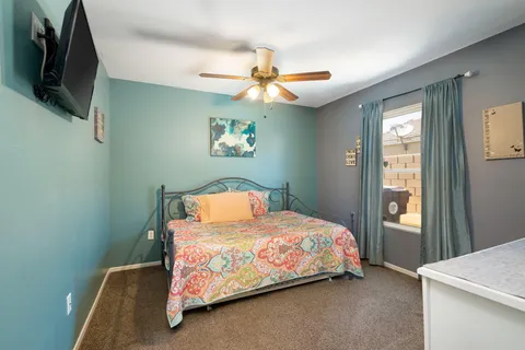 a bedroom with a bed and a flat screen tv