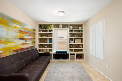 a living room with a couch and bookshelf