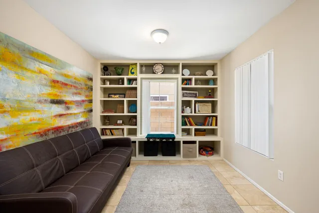 a living room with a couch and bookshelf