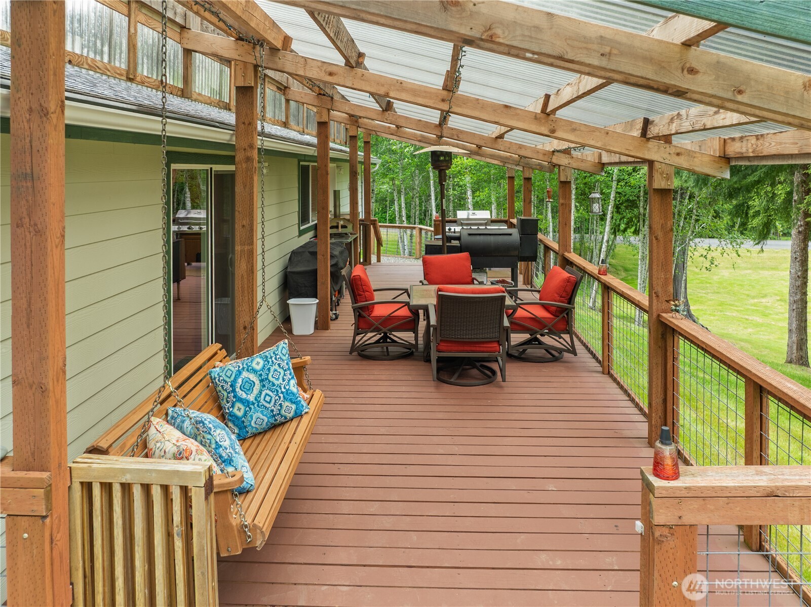 132 River Park Road Forks, WA 98331 - Photo 33 of 40 a view of a patio with table and chairs potted plants with wooden floor and fence