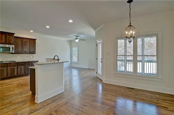 an empty room with closet and a ceiling fan
