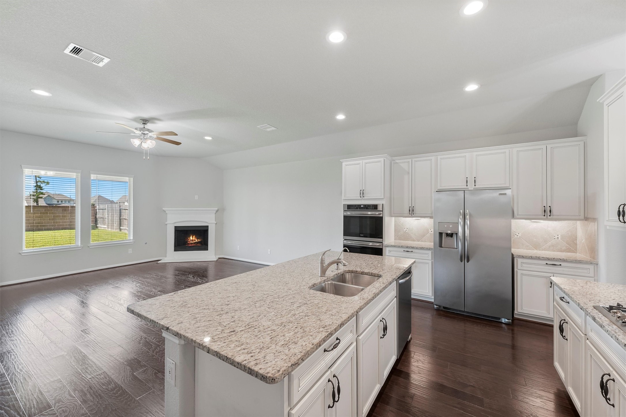12043 Talmadge Reach Drive Humble, TX 77346 - Photo 11 of 33 a kitchen with refrigerator cabinets and wooden floor