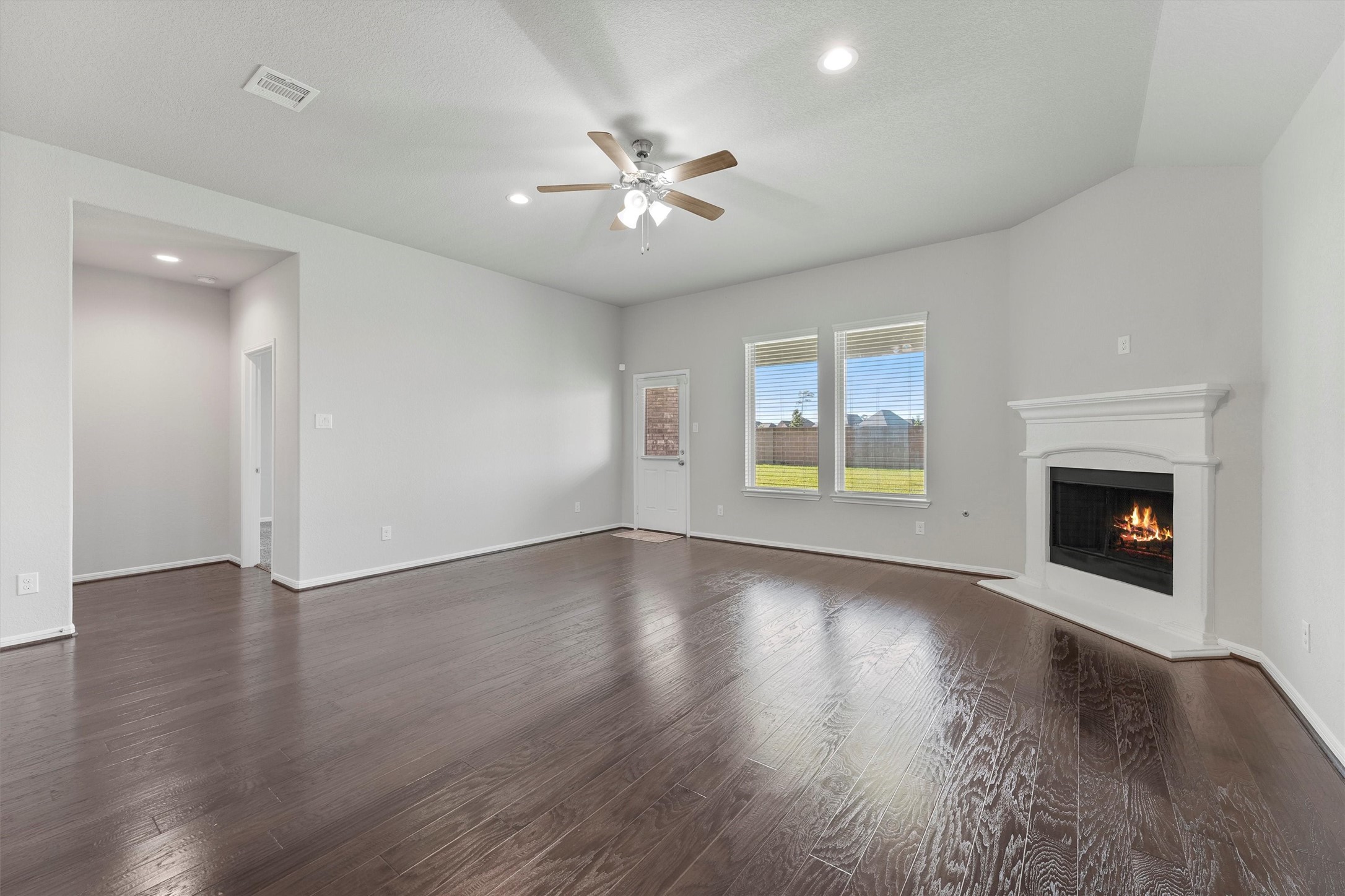 12043 Talmadge Reach Drive Humble, TX 77346 - Photo 12 of 33 an empty room with wooden floor fireplace and windows